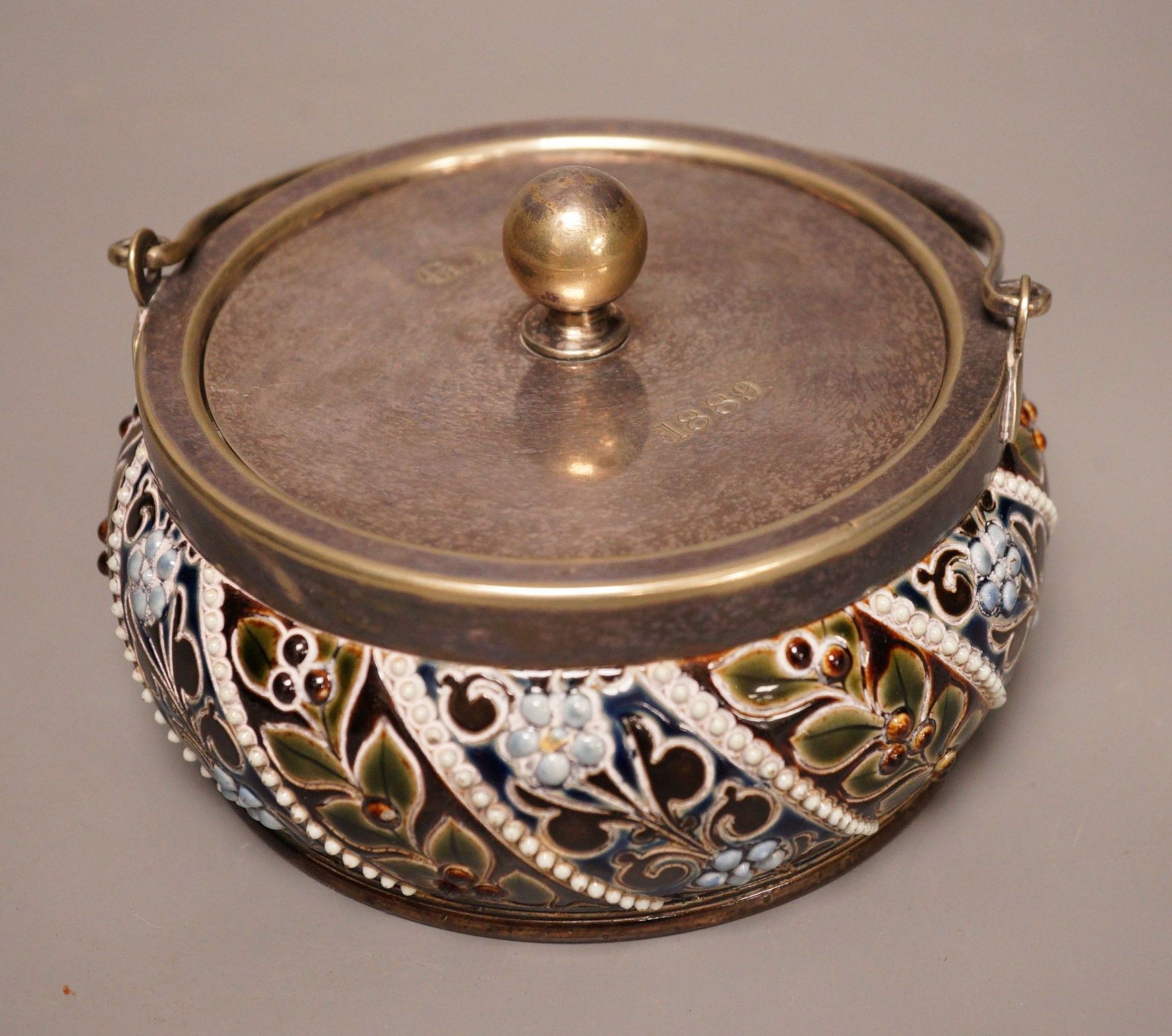 A Doulton style salt glaze stoneware lidded jar, marked HB, 8cm tall